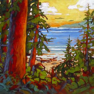 Sunlit coastal landscape with view to the beach from a path in the forest