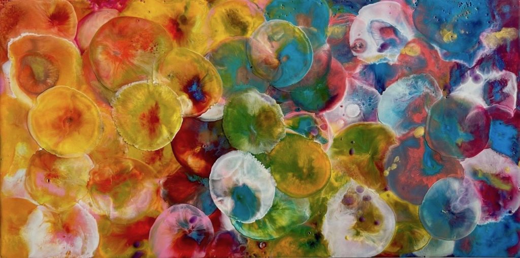 Colourful encaustic rectangular painting of abstracted jellyfish in yellow, orange, blue and green